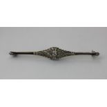 An Art Deco diamond bar brooch, in a pierced geometric setting, set with diamonds in millegrain