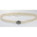 A cultured pearl, emerald and diamond necklace, comprising two rows of graduated pearls, strung