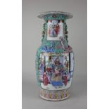A Chinese turquoise ground famille rose porcelain vase decorated with panels of figures amongst
