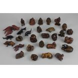 A collection of over twenty modern carved wood netsuke mostly animals, some signed