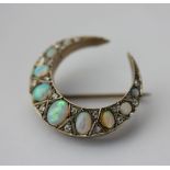 An opal and diamond crescent brooch, set with graduated opals cabochons and old cut diamonds, approx