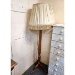 A carved mahogany four light standard lamp with reeded baluster stem and tripod base, 148cm