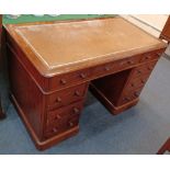 A Victorian mahogany pedestal desk with brown leather inset rectangular top above an arrangement