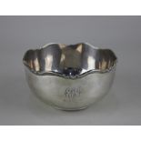 A George V silver circular bowl with shaped border, engraved initial and date, maker Atkin