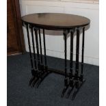 A mahogany nest of three oval side tables on turned supports 63cm