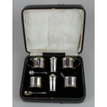 A cased set of six George V silver cruets to include a pair of mustard pots and covers, pair of