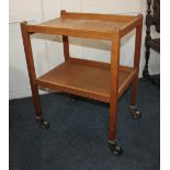 An oak two tier serving trolley on sprung rubber wheeled castors, 61cm