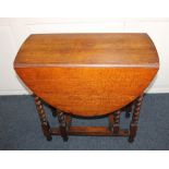An oval oak gateleg table with two drop flaps, on barley twist supports 103.5cm fully extended