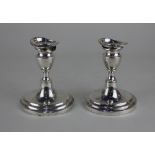 A pair of Danish silver dwarf candlesticks vase shape with detachable sconces on loaded circular