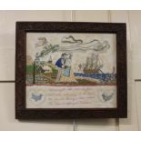 A framed needlework of a sailor and his sweetheart in a landscape with verse 'A magic spell will
