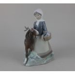 A Lladro porcelain figure group of a girl beside a goat 23cm high