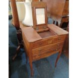 A continental, possibly French work table with three part rising top, central mirror and tambour