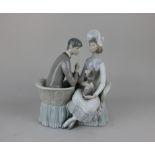 A Lladro porcelain figure group of a couple seated on a conversation sofa with a dog 28cm high