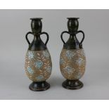 A pair of Royal Doulton Slaters Patent stoneware bottle vases, green glazed with floral decoration