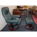 A green leather reclining swivel armchair and matching stool