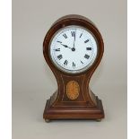 An Edwardian mahogany inlaid balloon shaped mantle clock the white enamel dial with Roman numerals