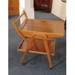 An Ercol style drinks trolley with sliding shelf above a removable tray, on castors 75.5cm high