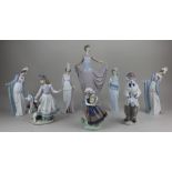 A collection of eight Lladro porcelain figures to include a dancer holding her skirts 30cm high,