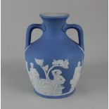 A blue jasperware 'Portland' vase with twin handles and frieze of classical figures, 20cm