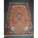 A Qashqai type rug, red ground, with floral medallions within multiple borders 131cm by 81cm