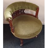 A Victorian upholstered tub chair with button upholstered back on pierced support, turned legs and