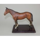 A Beswick model of a horse, matt glaze, mounted on a wooden base, 22cm high including base