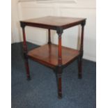 A mahogany two tier what-not, with hinged ratchet top (reading rest missing) on ring turned supports