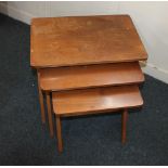 A mid 20th century nest of three side tables each with rectangular top with rounded corners, on