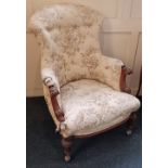 A Victorian armchair with carved scroll arms on tapered legs with later castors, (a/f in need of