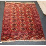Three rugs comprising a Bokhara style rug, red ground with repeat elephant foot motif within multip
