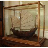 A wooden model of a Chinese junk in glazed oak display case case 78cm by 65cm