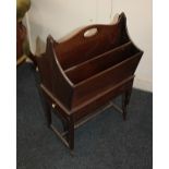 A mahogany four division magazine rack with a pierced handle and small drawer on slender outswept