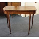 A George III mahogany tea table with d-shaped foldover top on square tapered legs and spade feet