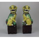 A pair of Chinese ceramic models of Dogs of Fo, in yellow, green and brown glaze 36cm high (a/f)