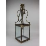 A brass hall lantern with four rectangular panes of glass and single light fitting 64cm high