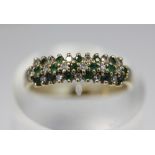 An emerald and diamond ring, claw set in three rows, ring size P, gross weight 2.3g