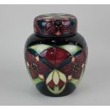 A Moorcroft pottery 'Trillium Nivale' pattern ginger jar and cover, decorated with red flowers