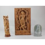 An Indian carved rectangular wooden wall plaque of a standing female nude figure entwined in