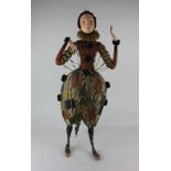 A 20th century costume doll dressed in theatrical Elizabethan style costume with painted face and