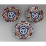 Three Japanese Imari side plates with wavy borders, 21cm