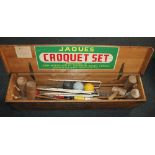 A Jaques croquet set in wooden case, containing four mallets, four balls, six hoops, markers etc.,