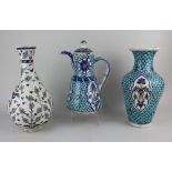 An Iznik coffee pot and baluster vase, both decorated with floral motifs on turquoise patterned