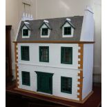 A modern Victorian style three storey dolls house, to include attic rooms, with white painted hinged