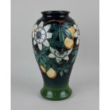 A Moorcroft pottery 'Passion Fruit' pattern baluster vase, blue green ground, marked as a second