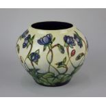 A Moorcroft pottery 'The Ashwood Hepatica' pattern squat vase decorated with blue flowers on