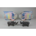 A pair of painted wooden tropical fish 25cm and a pair of carved stone models of Rhinocerus (a/f)