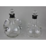 Two similar three handled glass decanters with silver mounts 24cm high including stopper