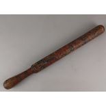 An early 19th century painted wooden truncheon with distressed coat of arms and initials JS, 46cm