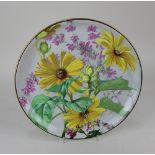 A Creil et Montereau porcelain charger decorated with yellow and pink flowers on pale grey ground,