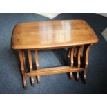 An Ercol nest of three rectangular side tables with pierced shaped end supports, 58cm